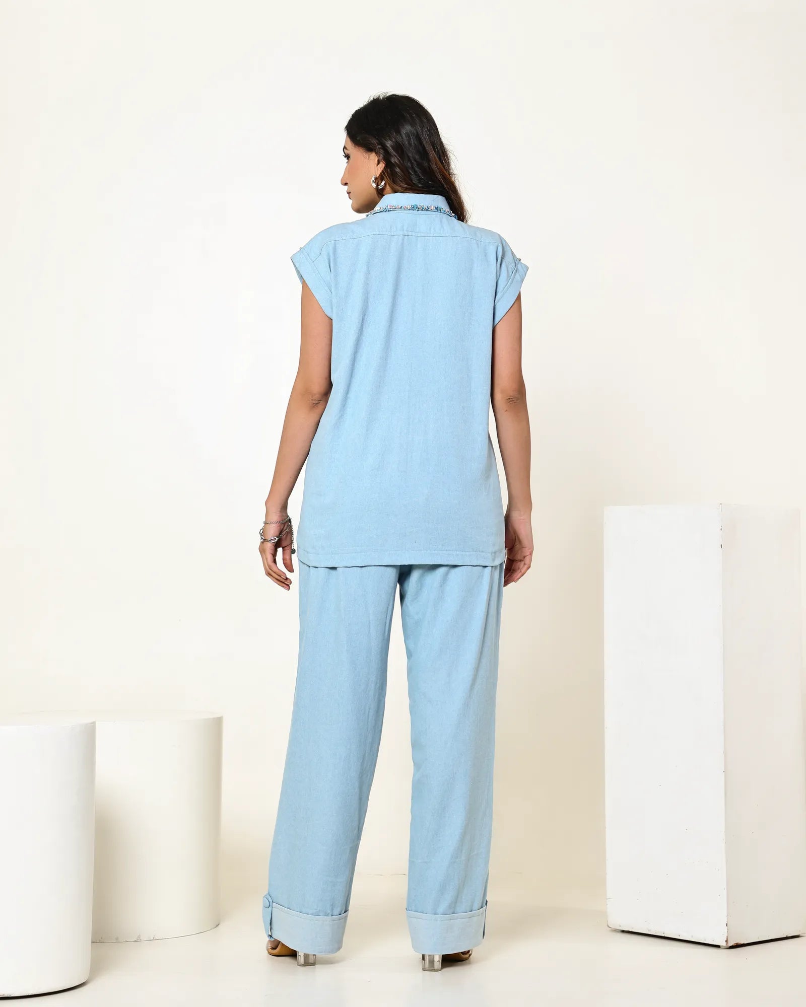 THE LIGHT DENIM SLEEVELESS FLAP EMBELLISHED SHIRT WITH HIGH WAISTED PANTS