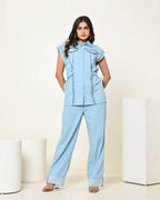 THE LIGHT DENIM SLEEVELESS FLAP EMBELLISHED SHIRT WITH HIGH WAISTED PANTS