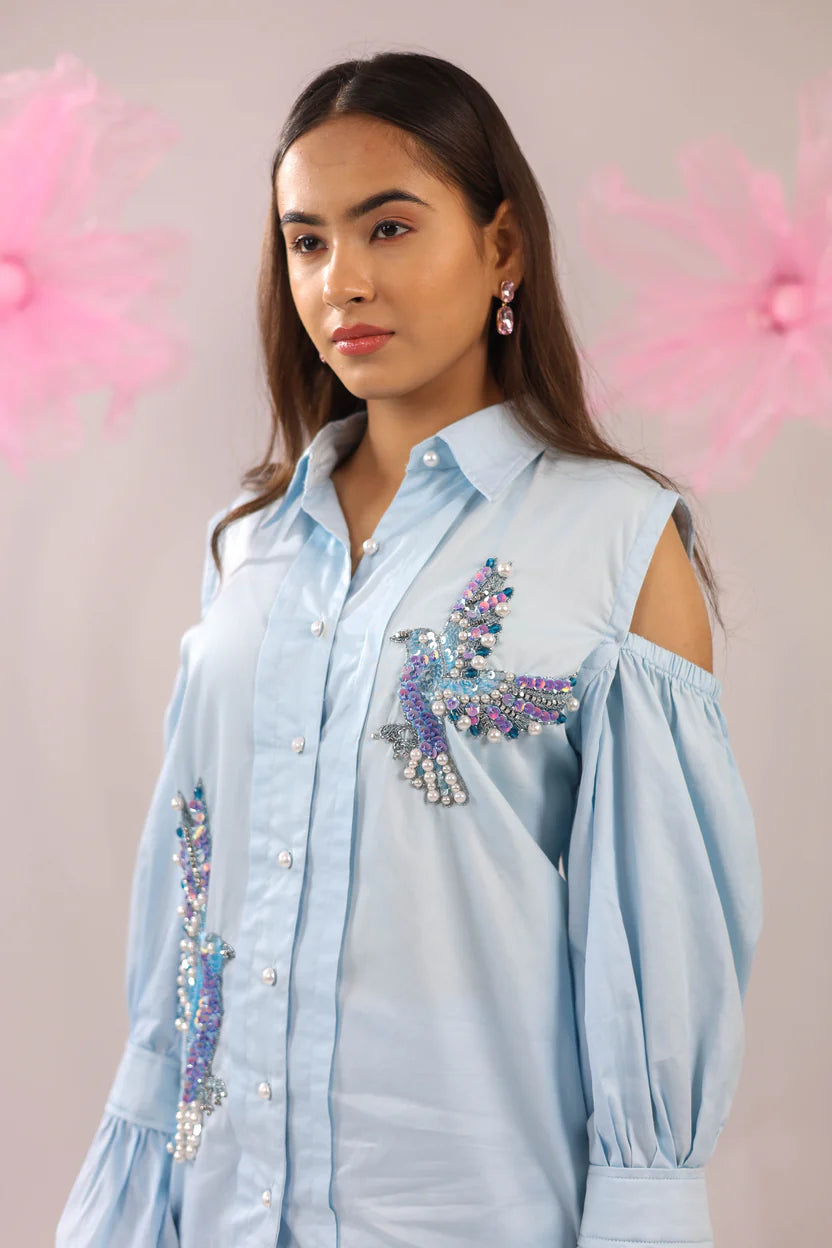 THE SKY BLUE COLD SHOULDER BIRD EMBELLISHED COTTON SHIRT